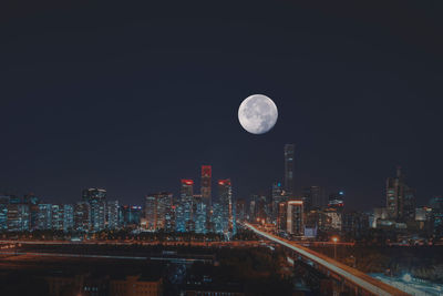 Illuminated cityscape against sky at night