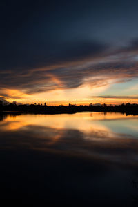 Scenic view of lake against romantic sky at sunset