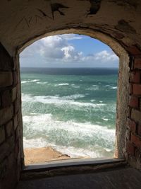Scenic view of sea against sky seen through window