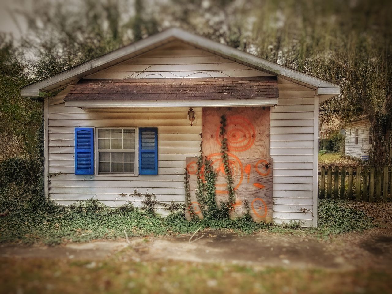 EXTERIOR OF HOUSE ON FIELD BY TREE