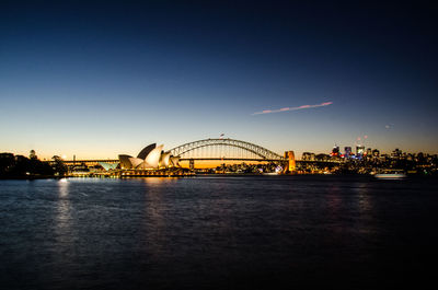 View of bridge over river at sunset