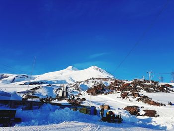 Scenic view of snowcapped mountains against blue sky