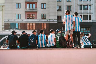 Rear view of people standing at town square