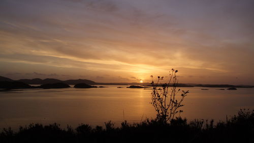 Scenic view of sea against orange sky