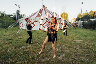 Male and female fire dancers practicing at circus