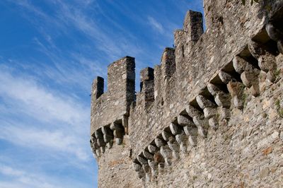 Low angle view of fort against cloudy sky