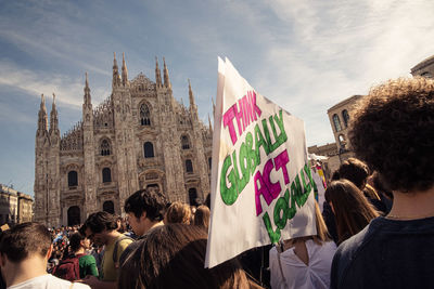 Group of people against buildings in city