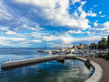 Scenic view of swimming pool by sea against sky