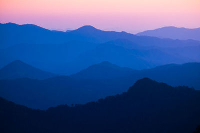 Scenic view of silhouette mountains against sky during sunset