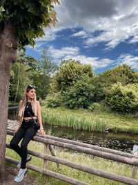 Woman in park against sky