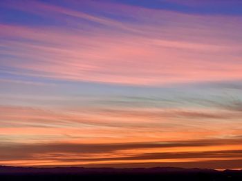 Scenic view of dramatic sky over sea during sunset