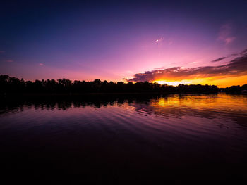 Scenic view of lake against romantic sky at sunset
