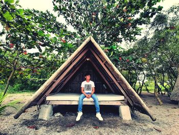 Low angle view of man standing by tree