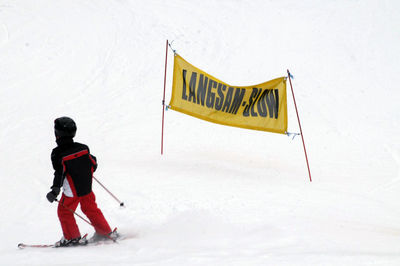 Rear view of man skiing on snow