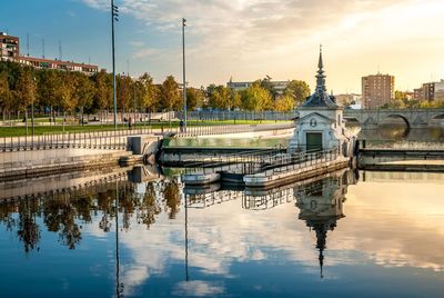 Reflections in river in city