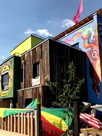 Multi colored flags against built structure