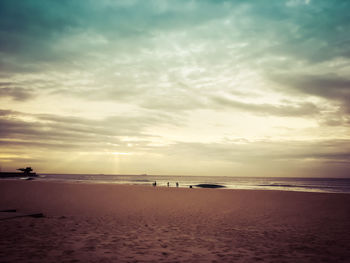 Scenic view of beach against sky during sunset