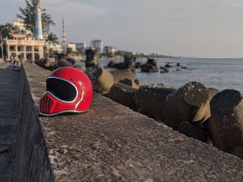 Close-up of sunglasses on beach against sky