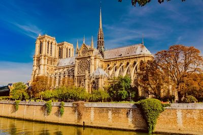 Low angle view of notre dame de paris against blue sky