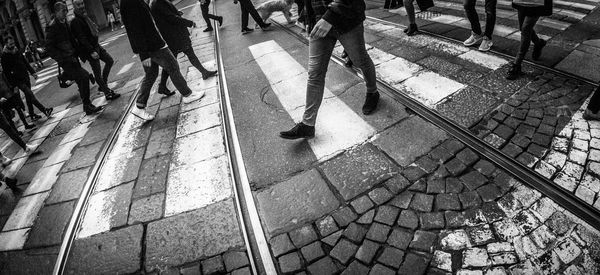 Low section of people walking on footpath