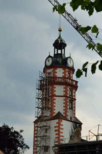 Low angle view of building against cloudy sky