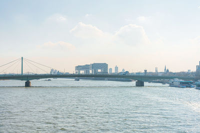 Bridge over river with city in background