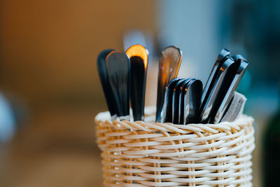 Close-up of spoons in wicker container