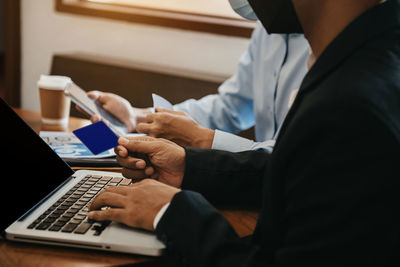 Midsection of man using laptop