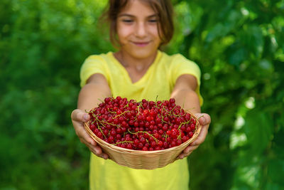 Girl holding berries in basket