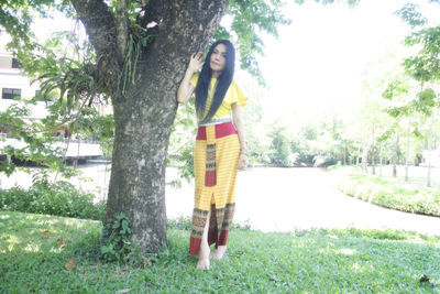 Portrait of woman standing by plants