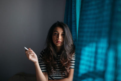 Portrait of young woman smoking