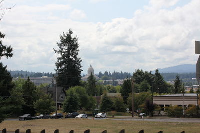 Cars on landscape against sky