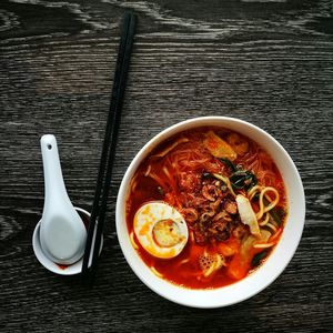 Directly above shot of noodles with chopsticks served on table