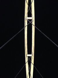 Low angle view of metallic structure against sky at night