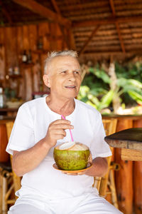 Portrait of young man sitting at home