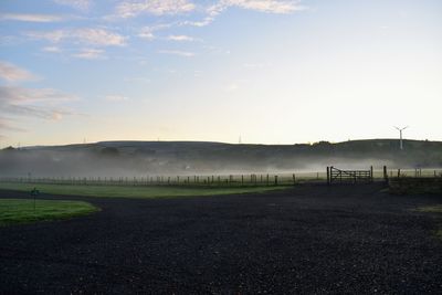 Scenic view of field against sky during sunset