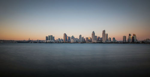 View of city at waterfront during sunset