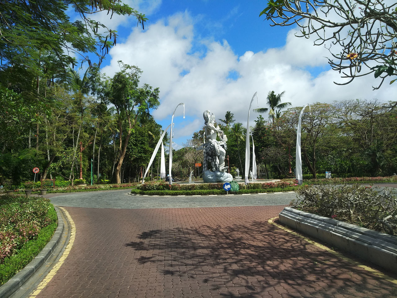 VIEW OF PARK AGAINST CLOUDY SKY