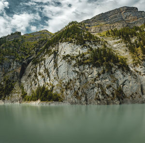 Scenic view of mountains against cloudy sky