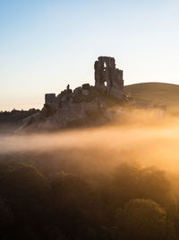 View of old ruin building against clear sky during sunset