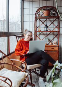 Young woman using laptop at home