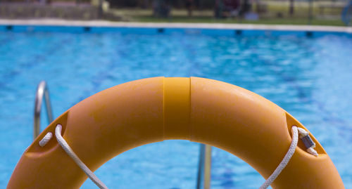 Close-up of life belt against swimming pool
