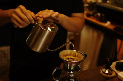 Man pouring coffee in cup