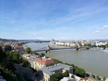 High angle view of river by buildings in city against sky