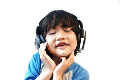 Portrait of smiling boy against white background