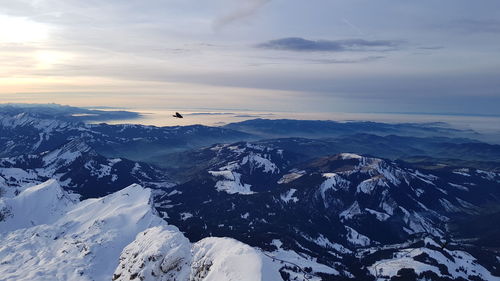 Scenic view of snowcapped mountains against sky during winter