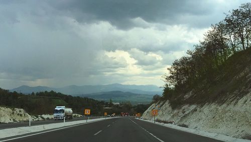 Cars on road against sky