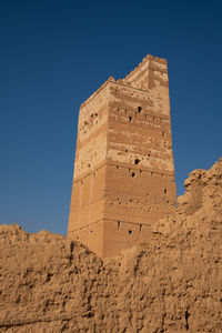 Low angle view of historical building against blue sky