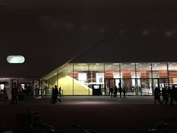 People in illuminated city at night