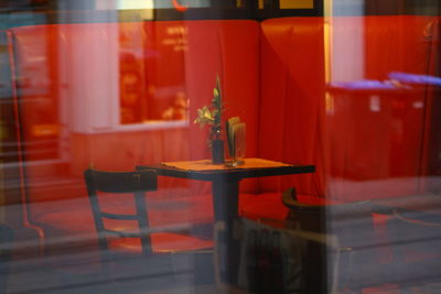 Close-up of red chairs on table